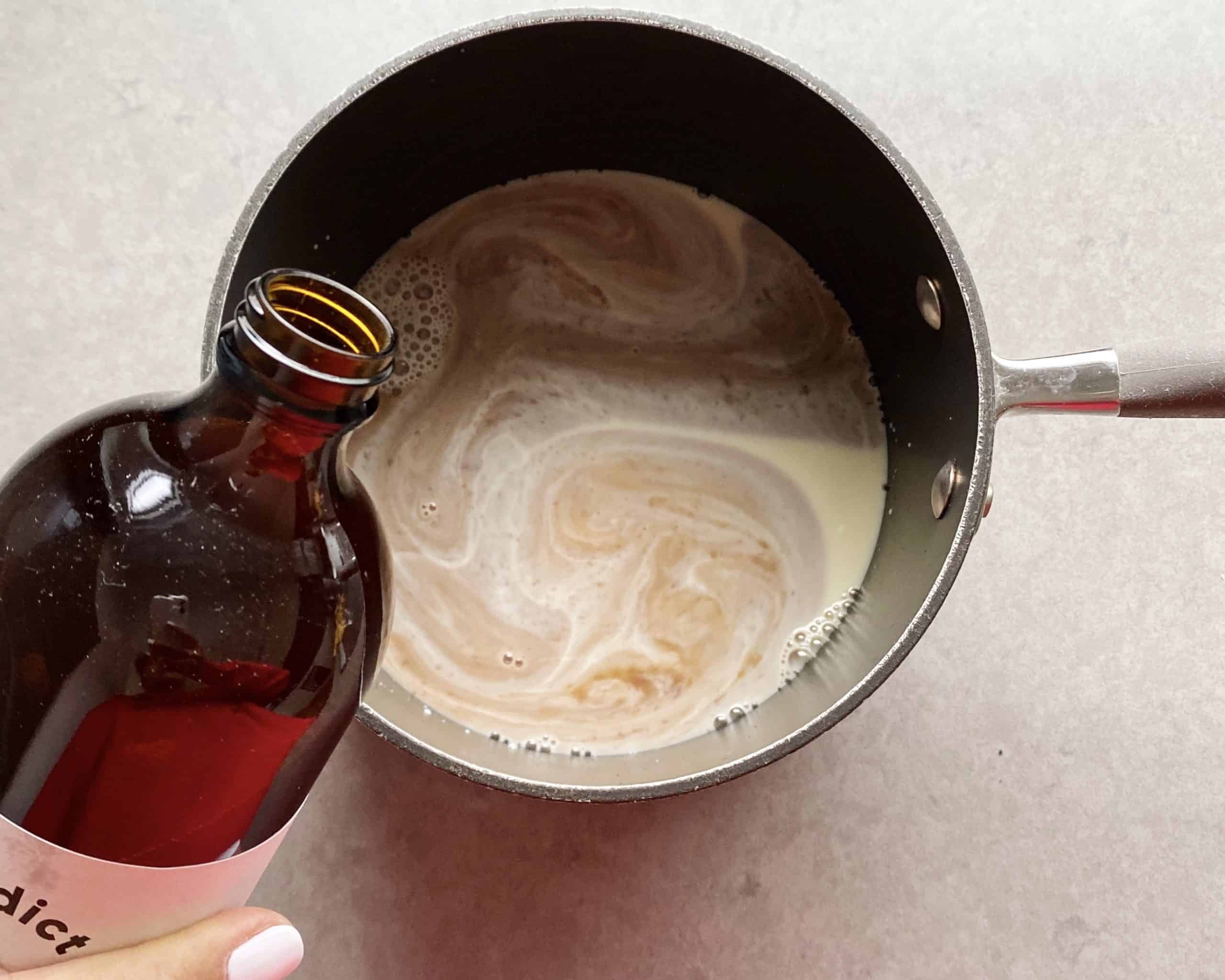 pot filled with milk and dirty chai tea concentrate to make a dirty chai latte