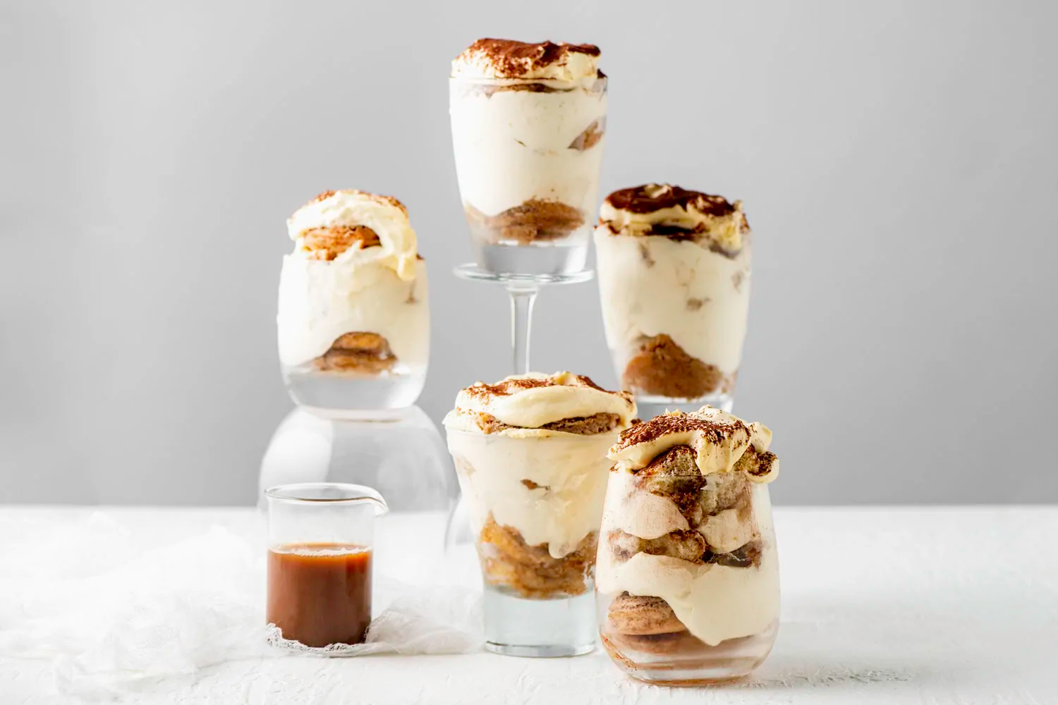 A clear glass tower of Dirty Chai tiramisu by Chai Addict