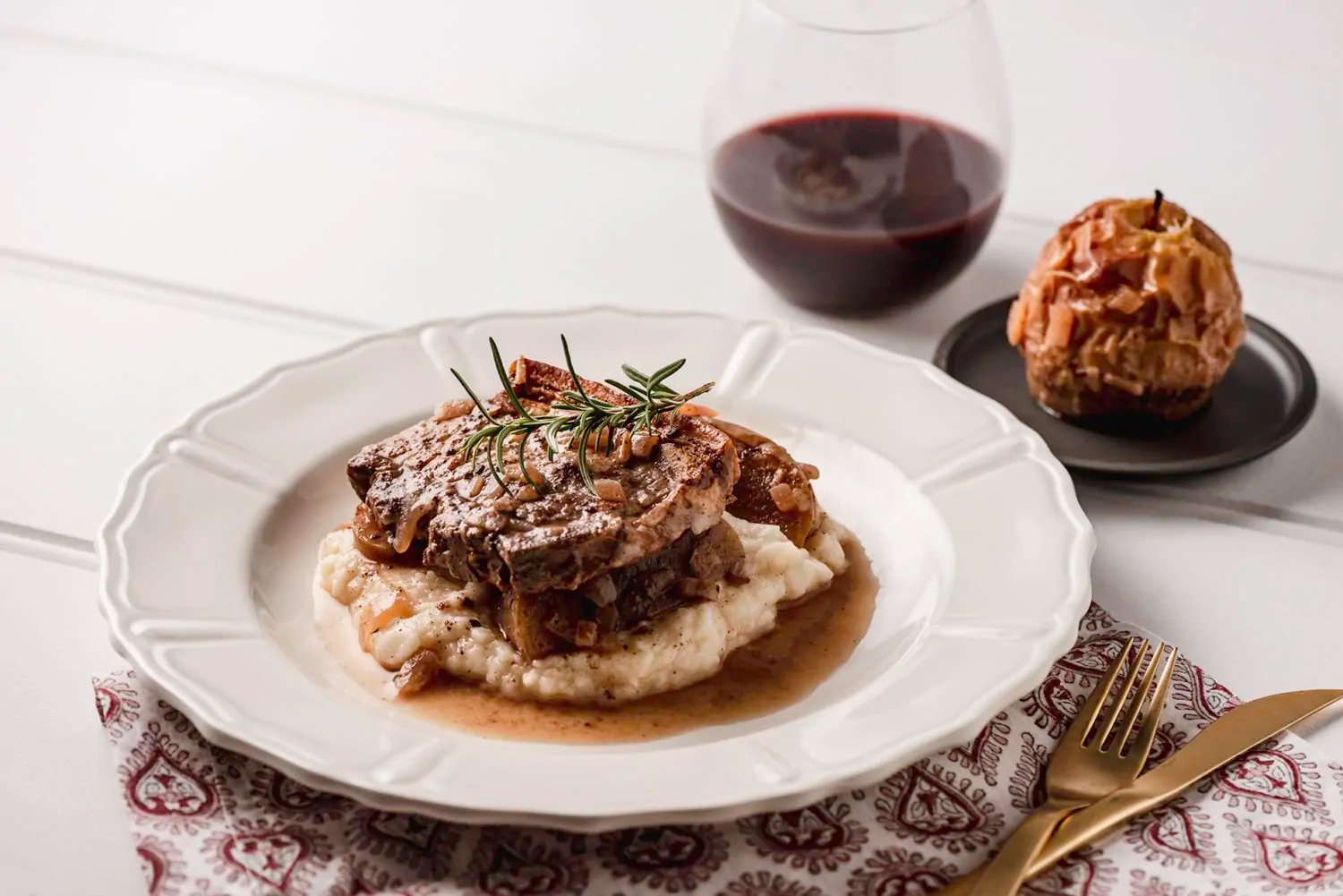 plate of chops and chai cider on a bed of mashed potato