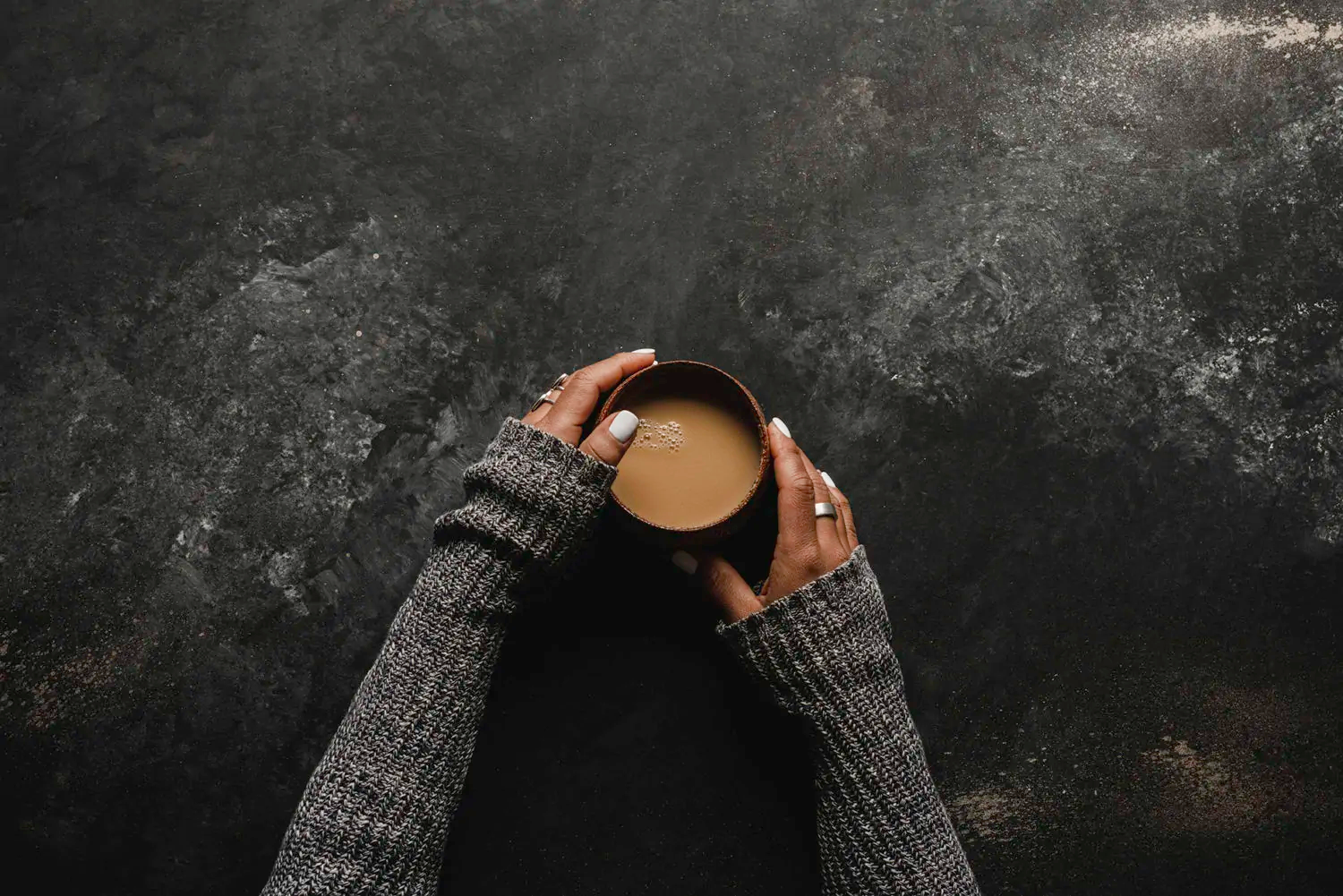 person holding a cup of creamy White Hot Chocolate Chai