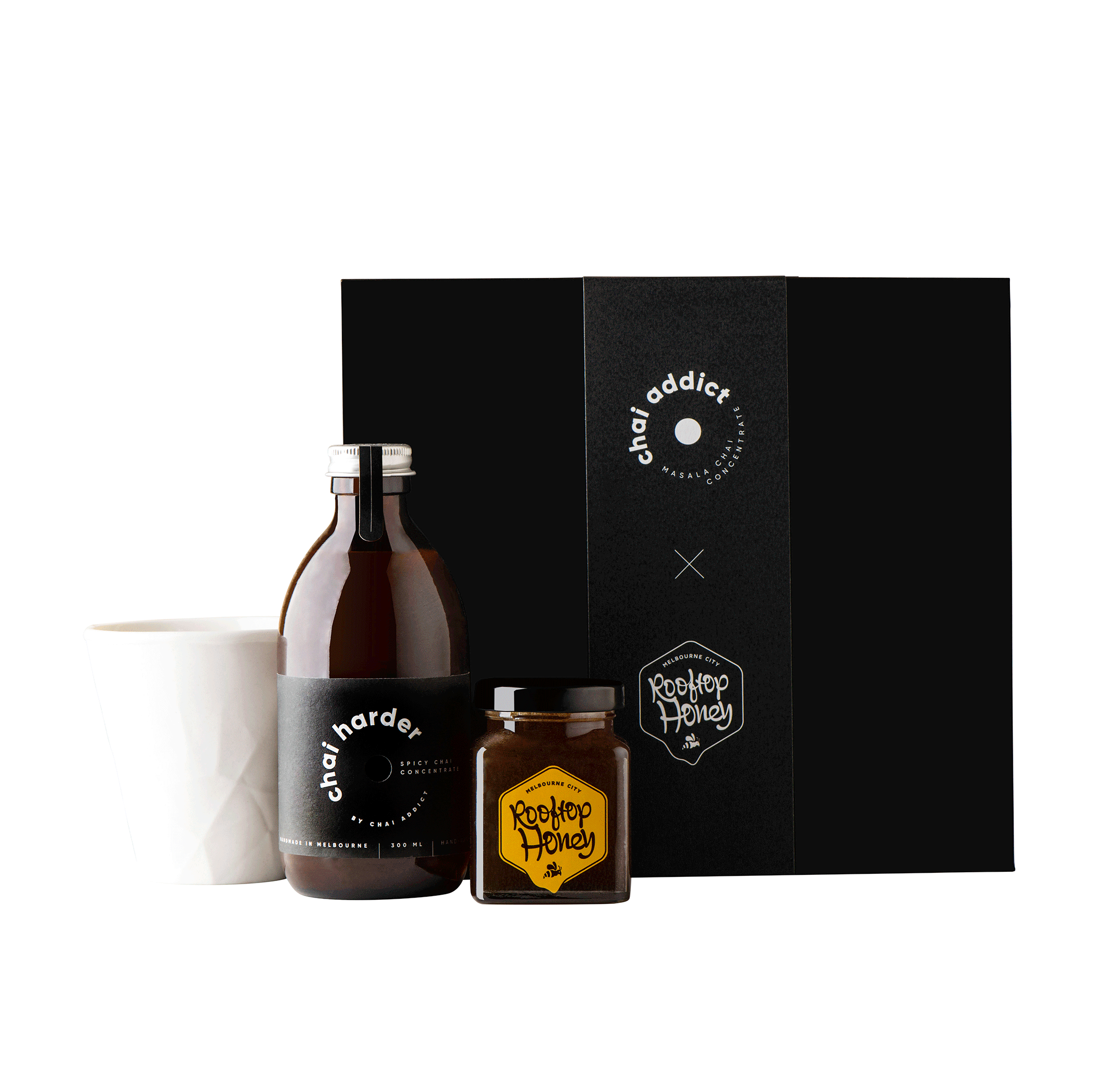 chai addict gift box with white ceramic cup, bottle of 300ml chai harder concentrate, jar of honey and jigger
