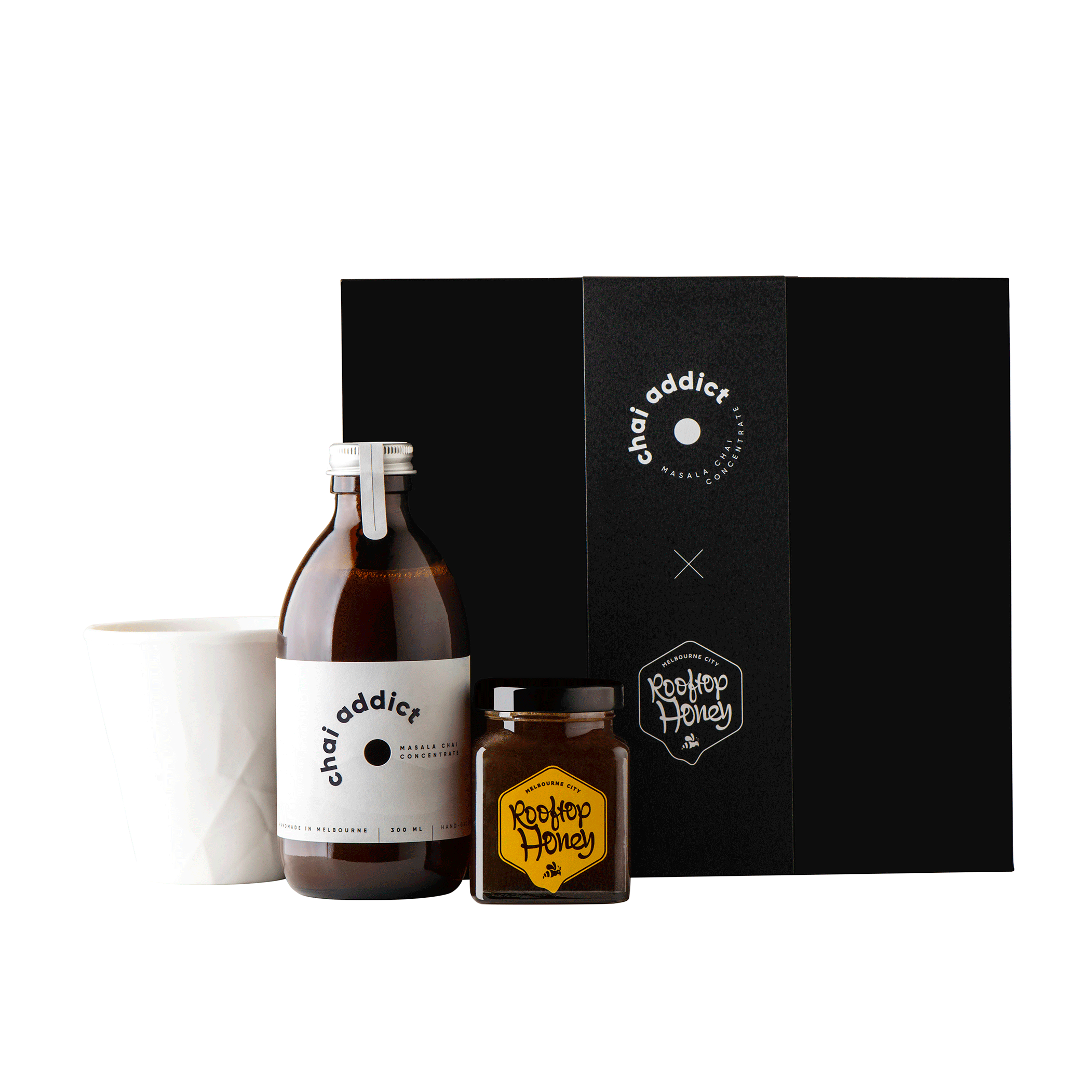chai addict gift box with white ceramic cup, bottle of 300ml chai latte concentrate, jar of honey and jigger