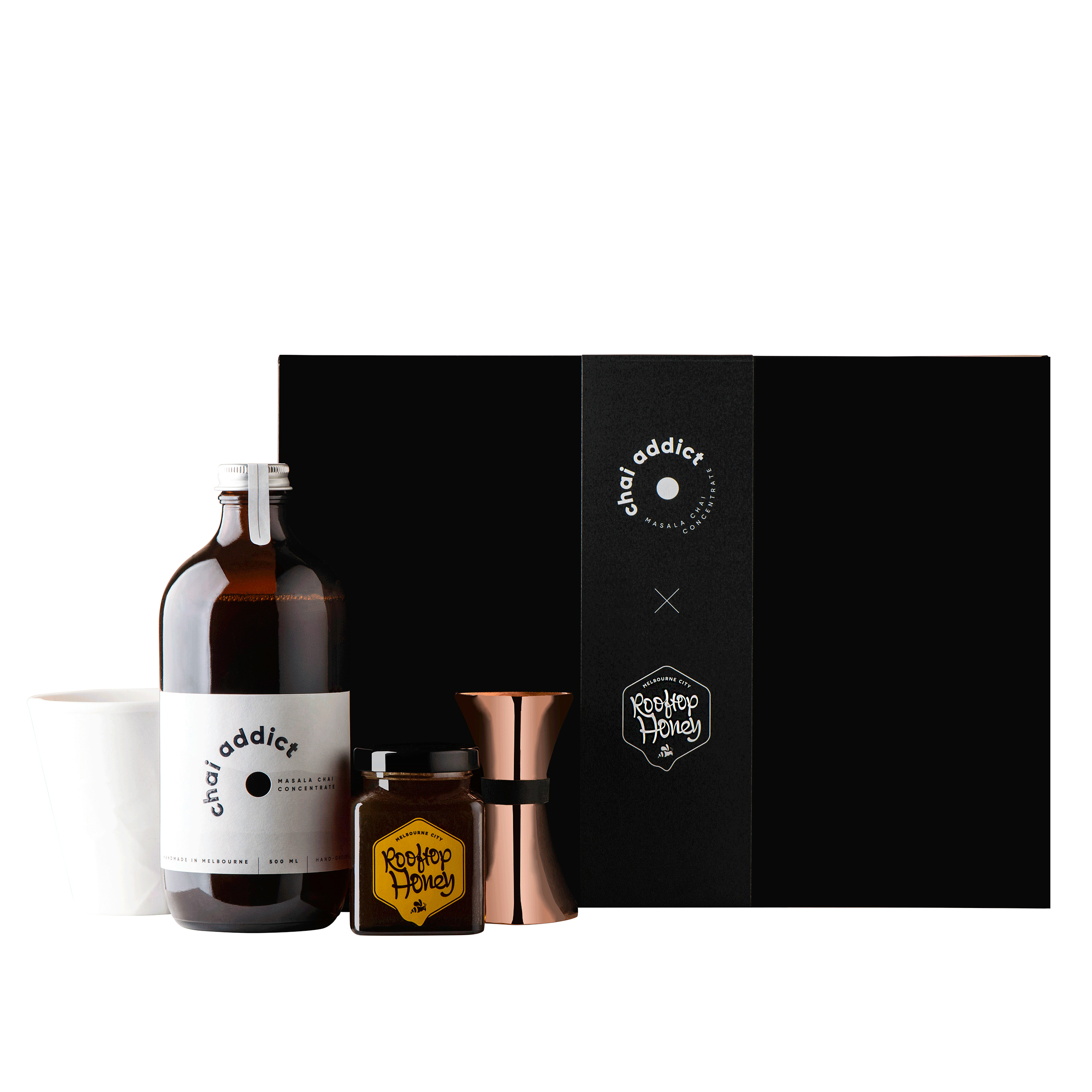 chai addict gift box with white ceramic cup, bottle of chai latte concentrate, jar of honey and jigger