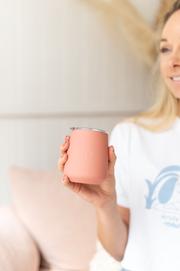 woman holding caye life terracotta keep cup