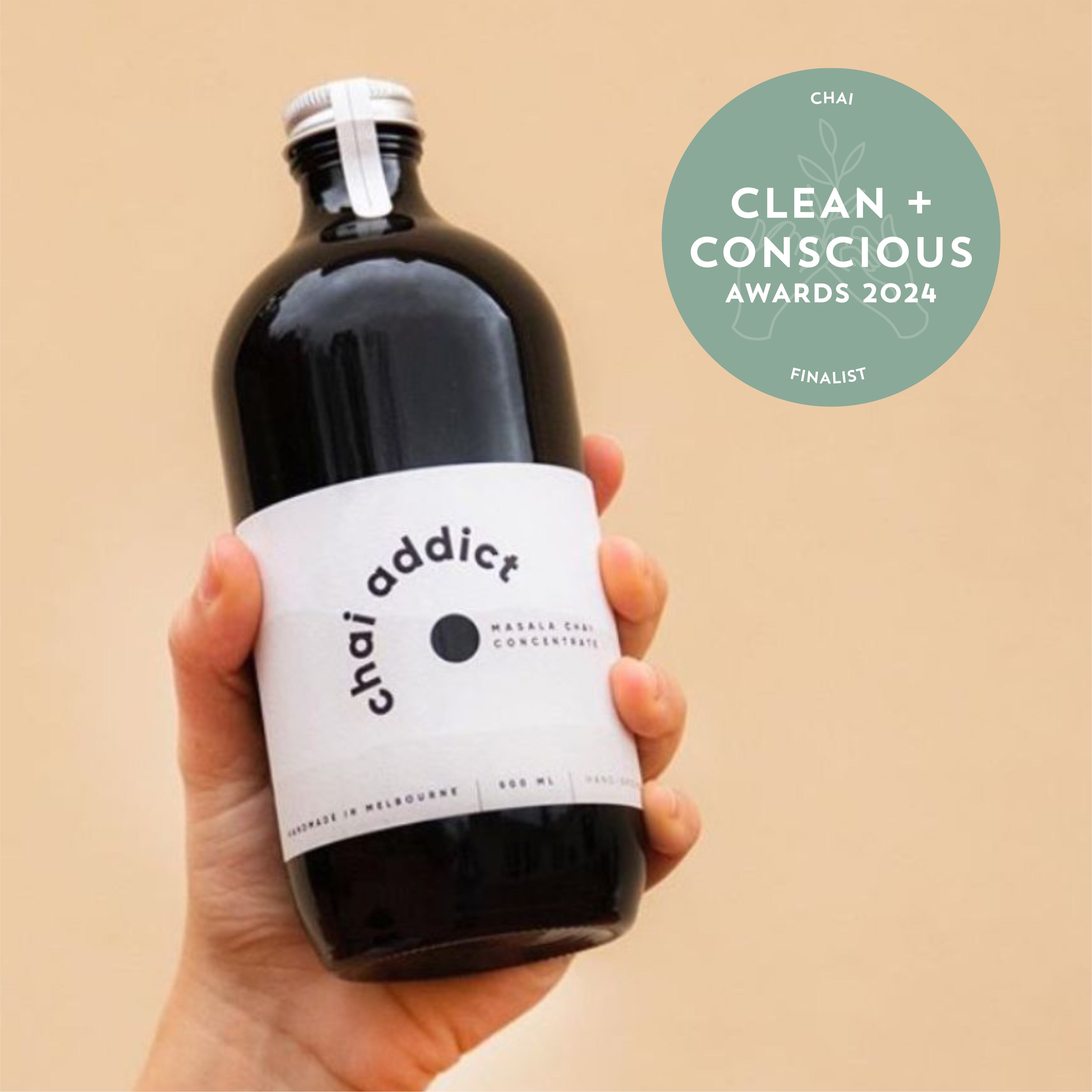 hand holding chai addict 500ml bottle with a clean + conscious awards finalist 2024 tile