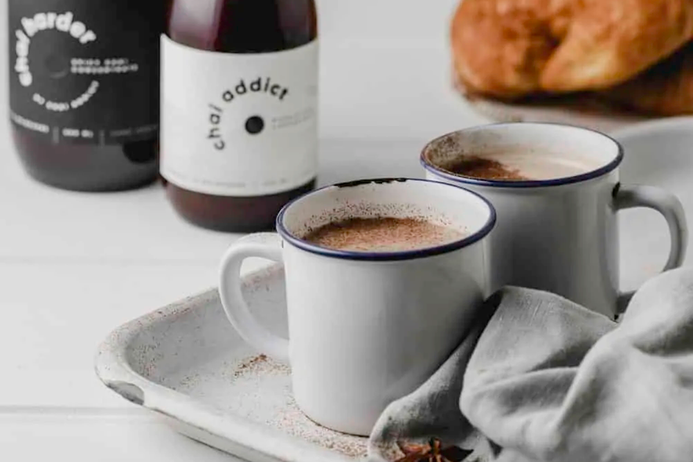 two cups of chai latte brewed by chai addict
